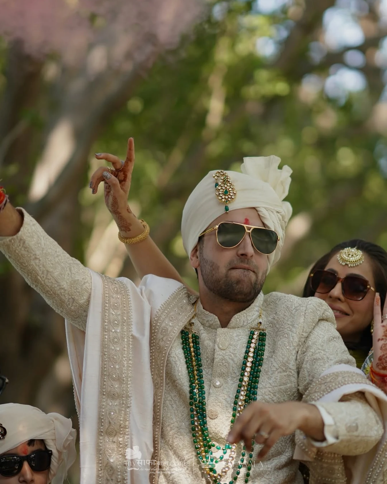 Groom in an ivory wedding safa with emerald jewellery for Bamburi